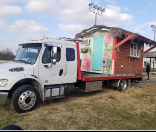 Oversized structure being transported on flatbed